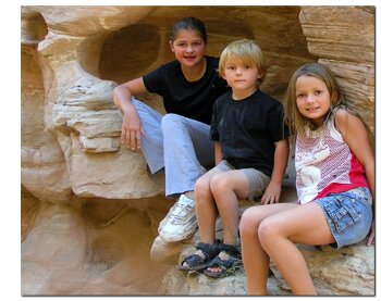 Kids enjoy the cubby holes in the slot canyons of the Grand Staircase National Monument