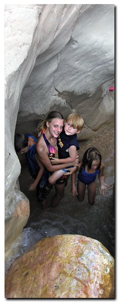 Kids play in a slot canyon in the Grand Staircase National Monument