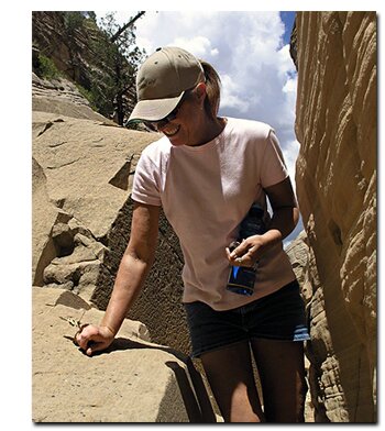 A butterfly lands on Patty Milligan's hand while she hikes Lick Wash in the Grand Staircase National Monument